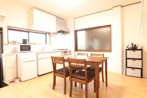 a kitchen with a wooden table and chairs in a room at AZ HOTEL - Vacation STAY 56046v in Sumoto