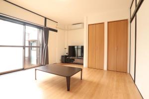 a living room with a coffee table and a tv at AZ HOTEL - Vacation STAY 56046v in Sumoto