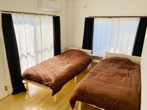 a bedroom with two beds and a window at AZ HOTEL - Vacation STAY 56046v in Sumoto