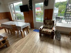 a living room with a dining room table and chairs at Bakuriani Mtis 6 in Bakuriani