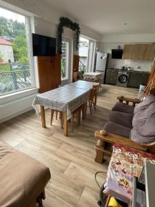 a living room with a table and chairs and a kitchen at Bakuriani Mtis 6 in Bakuriani