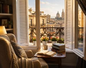 a room with a chair and a table with books at new colmbia in Cairo