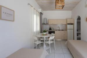 a kitchen and a table and chairs in a room at Nikolas Apartments in Amoudara Herakliou +64 photos