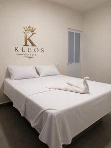a white bed with a duck sitting on top of it at Hotel Kleos in Cárdenas