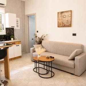 a living room with a couch and a table at Endless Green Villa in Argostoli