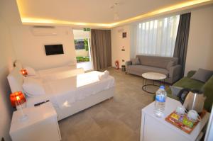 a living room with a couch and a living room at Fethiye Cagri Pansiyon in Fethiye +17 photos