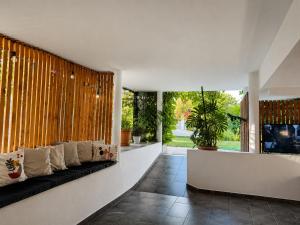 a living room with a couch and a large window at Vila Laura in Ksamil