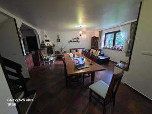 a living room with a table with a laptop on it at Pensiunea Daria Putna in Putna