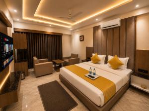 a hotel room with a bed and a television at Hotel The Sun B&B in New Delhi +19 photos