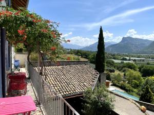 a house with a balcony with a view of the mountains at L'estive de Doris in Remollon