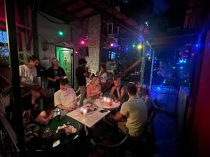 a group of people sitting at a table in a bar at YOLO Hostel in Istanbul