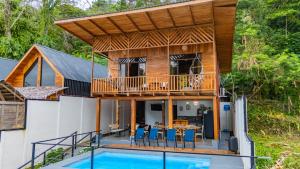 a house with a deck and a pool at Jacaranda House, rustic, Private Pool in Talamanca