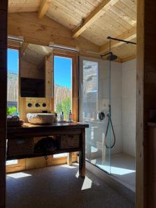 a bathroom with a shower and a wooden ceiling at Love Nest by taste of Antiparos in Antiparos
