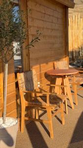 a wooden table and two chairs and a table and a table at Love Nest by taste of Antiparos in Antiparos