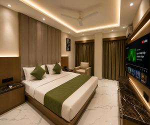 a hotel room with a bed and a television at Hotel The Sun B&B in New Delhi