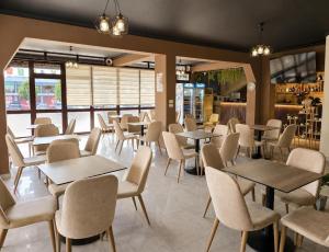 a dining room with tables and chairs in a restaurant at Hotel Danja in Laç