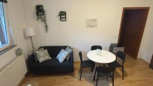 a living room with a couch and a table at The Nook Apartment in Jesenice