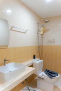 a bathroom with a sink and a toilet and a shower at PGD brown city view in Rawai Beach