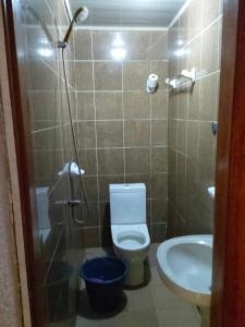 a bathroom with a toilet and a sink at Résidence New Land Sarl in Douala
