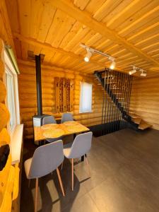 a room with a table and chairs and a staircase at Mountain View in Vyshkove