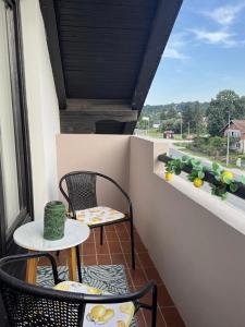 a balcony with two chairs and a table at Apartment Luvera in Ludbreg