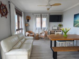 a living room with a couch and a table at Apartamentos Mareventus in Sanxenxo