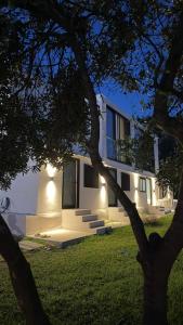 a house with lights on the side of it at Escape Suites in Dhërmi