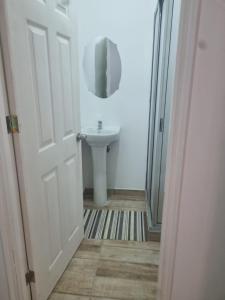 a bathroom with a sink and a white door at Hotel santa Rosa 2 in Ovalle