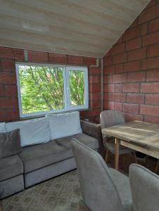 a living room with a couch and a table at Sevan Grass and Sky in Sevan