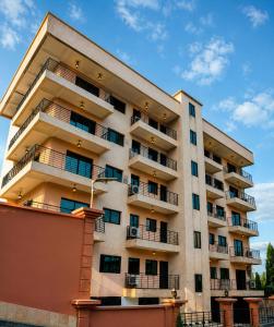 an apartment building with balconies on the side of it at Résidence New Land Sarl in Douala