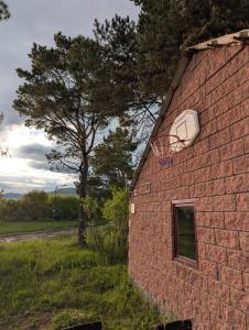 a brick building with a basketball hoop on the side of it at Sevan Grass and Sky in Sevan