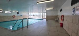 a swimming pool in a building with a pool at Hibernian Towers 408 in Strand