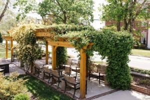 a wooden gazebo with chairs and plants at The Edenton Collection – Captain’s Quarters Inn in Edenton
