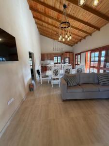 a living room with a couch and a dining room at Villa Pincho in Constanza