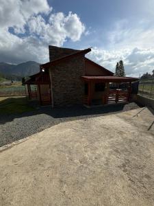 a small brick building with a dirt road in front of it at Villa Pincho in Constanza