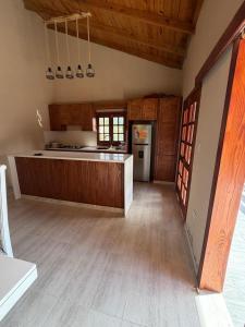 a large kitchen with wooden floors and a counter top at Villa Pincho in Constanza