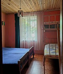 a bedroom with two bunk beds and a window at Hostel Ureki Kidobani in Ureki