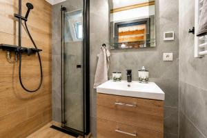 a bathroom with a sink and a shower at Norova chata in Závažná Poruba +19 photos