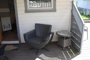 a chair sitting on the porch of a house at Visit Senja Lady in Senja