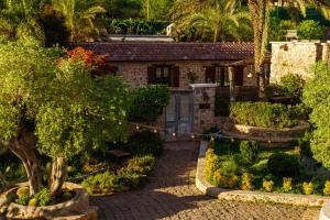 a house with a garden in front of it at Kassandra Heritage in Oludeniz