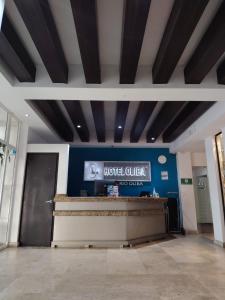 a hotel lobby with a hotel guide sign on the wall at HOTEL OLIBA Boca del Rio in Boca del Río