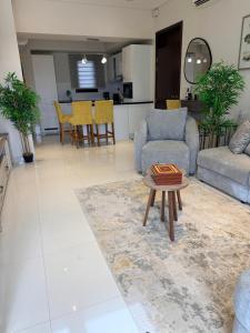 a living room with a couch and a table at Zill Hawana in Ma‘mūrah +8 photos