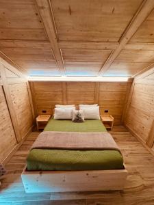 a bedroom with a bed in a wooden room at La Gemma Bed & Breakfast in Montesover