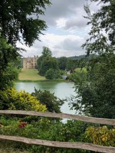 a view of a lake with a castle in the background at The Rest-Well Lodge in Sherborne