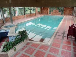 a large swimming pool in a house at Touristic House Chalet Luna Verde in Sasaima