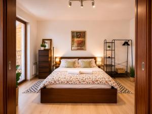 a bedroom with a large bed in a room at Ski & Sun Wellness Apartments in Liptovský Mikuláš