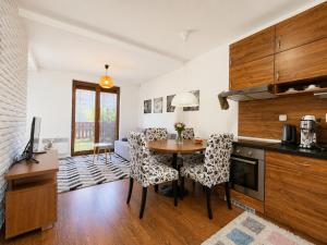 a kitchen with a table and chairs in a room at Ski & Sun Wellness Apartments in Liptovský Mikuláš