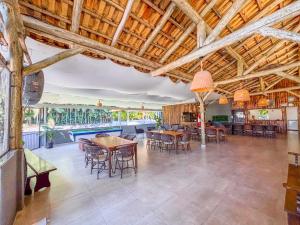 a large room with tables and chairs and a pool at Recanto R-12 in Rodeio Doze