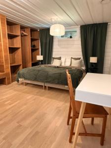 a bedroom with a bed and a table and a desk at Villa Älva i Sälen in Sälen