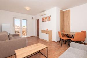 a living room with a couch and a table at Apartment Veslo in Begovići